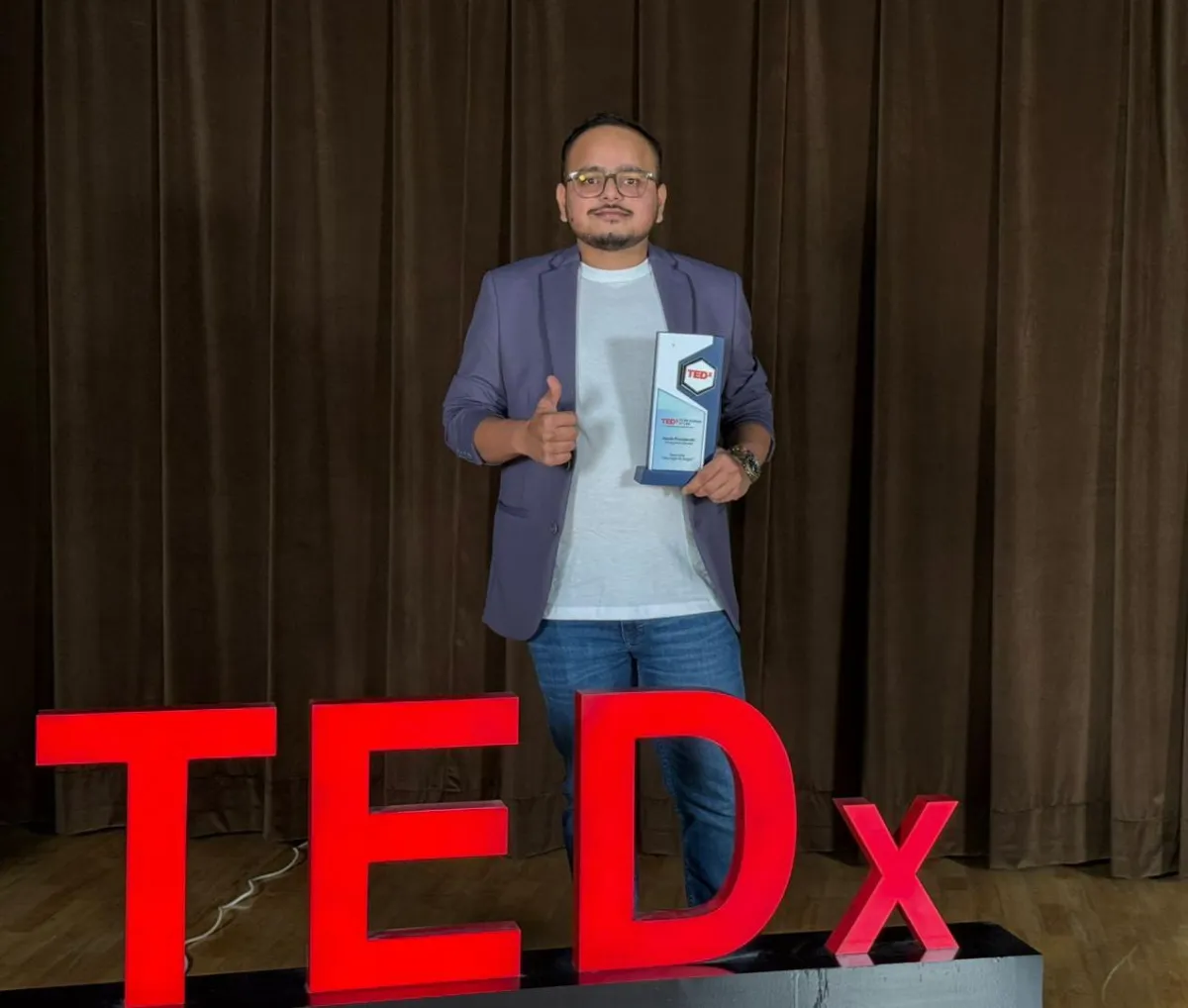 Harsh, founder of Skin Business Accelerator, with his TEDx award